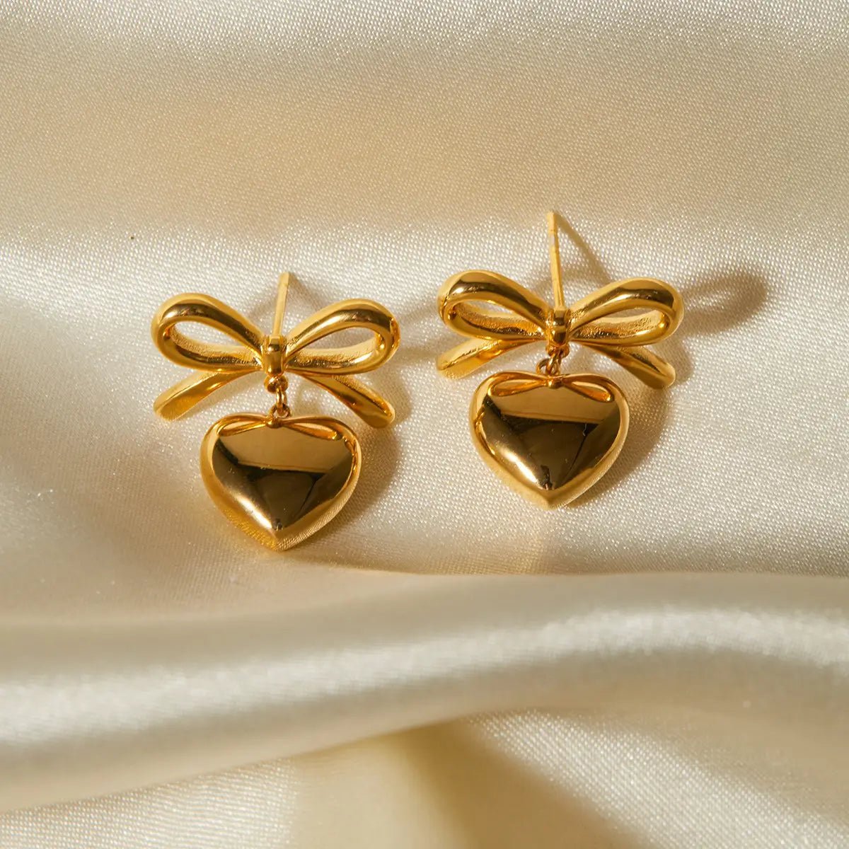 Elegant Heart Shape Bow Knot Drop Earrings With Gold Plated Finish - TIRAAYA
